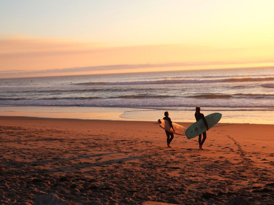 two surfers on empty beach